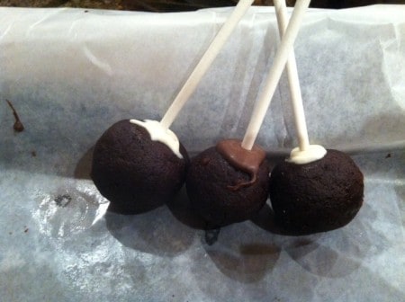 Secure the sticks in the cake pops with melting chocolate and set in freezer